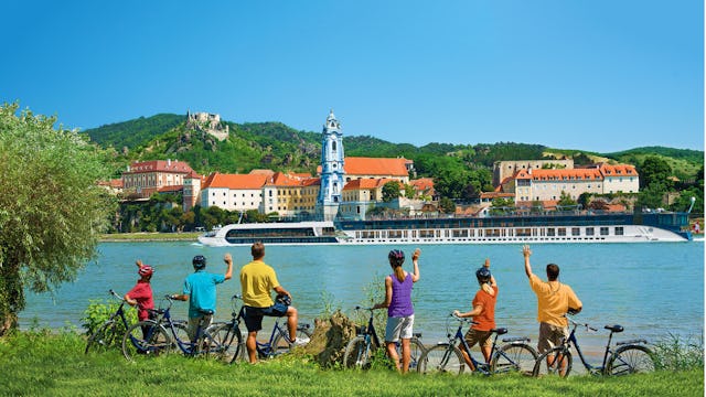 Guests waving to ship from their bike tour