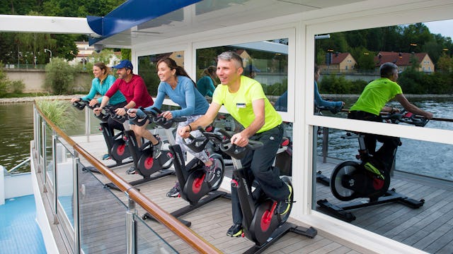 Guests enjoying a cycle class with a view on top deck