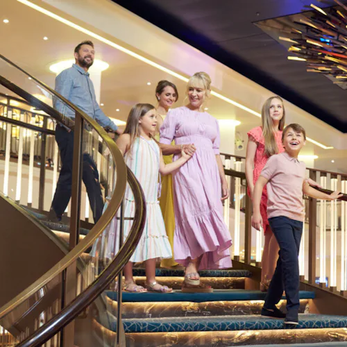 Family walking into the Atrium onboard